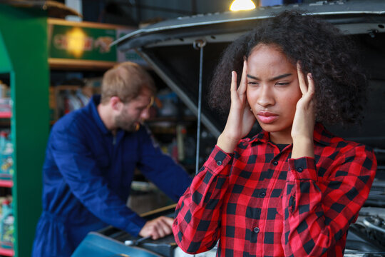 woman feeling worry about her car in garage - Powered by Adobe