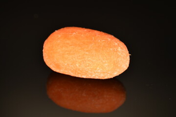 Ripe juicy organic mini carrots, close-up, on a black background.