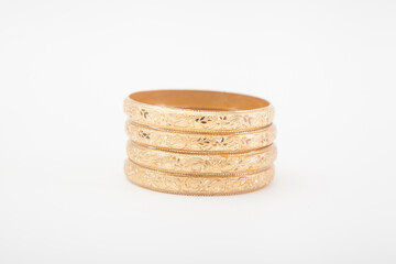 Set of massive golden bracelets on white background