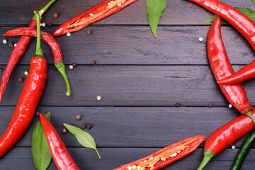Red chili and peppers on a dark vintage wooden table top view