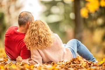 Man and woman having an autumn picnic outdoors