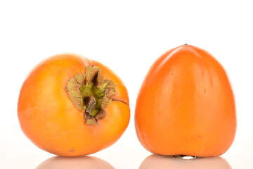 Ripe juicy organic persimmon, close-up, on a white background.