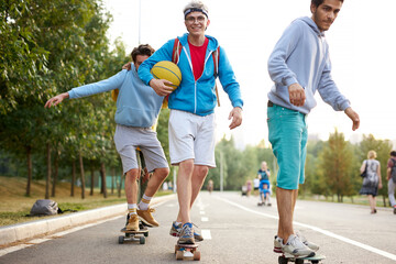 portrait of young sportive team of teenagers with skateboards, caucasina boys engaged in sport,...