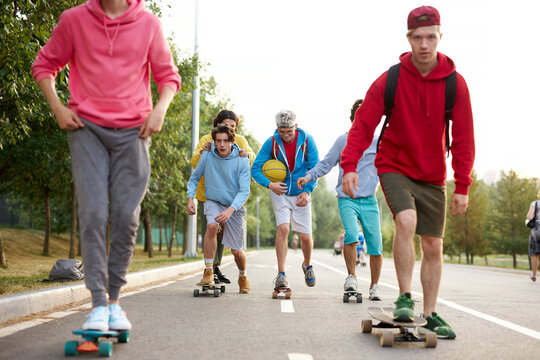 happy teenagers skateboarder boys have fun outdoors, caucasian youth generation freetime spending concept image