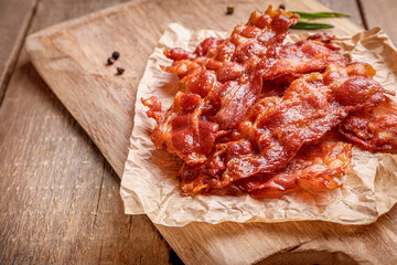 Tasty fried crispy bacon slices