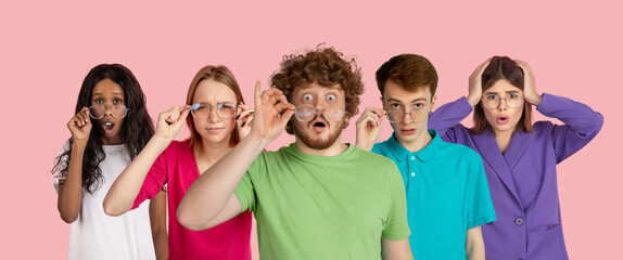 Shocked, astonished. Portrait of young people on pink coral background. Flyer, art collage made of 5 models. Concept of human emotions, facial expression, sales, ad. Gesturing, posing. Copyspace.