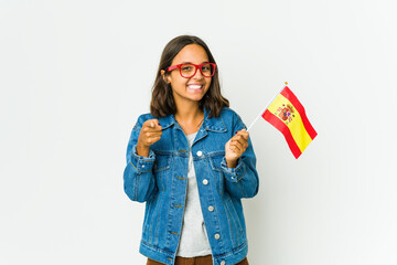 Young spanish woman holding a flag isolated on white background