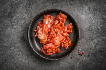 Tasty fried crispy bacon slices