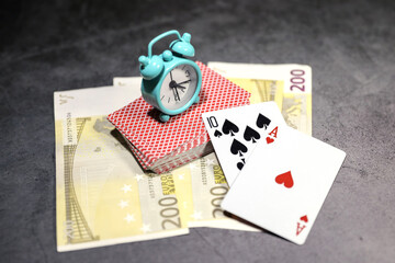 A pair of aces on a deck of playing cards with euro banknotes on a table. Online gambling. Gambling addiction	