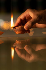 Diwali Diya on hand With Bokeh Light Background