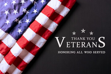 Fototapeta premium American flag on black background with text. Thank you Veterans.