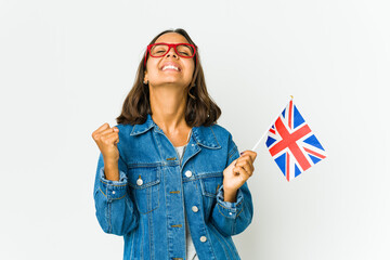 Young latin woman holding a english flag isolated on white background