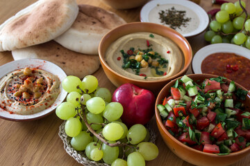 Food of Israel on a table. Top view photo of fresh made hummus, falafels and pita bread. Healthy eating concept. 