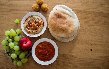 Israeli food close up photo. Falafels, hummea and pita bread on a table. 
