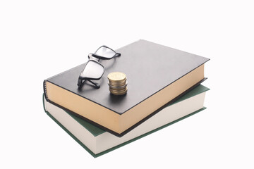 two books, pair of reading glass and  piled coins  isolated on white background with clipping path and copy space for your text