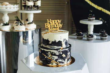 Fresh delicious birthday cake with words candles on gold plate