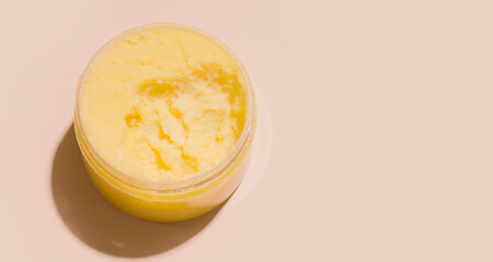 Body scrub in a jar on a beige background. copy space.
