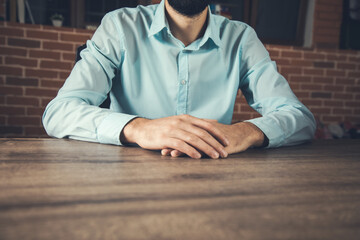 Fototapeta premium businessman cross hands in the desk