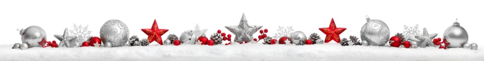 Christmas border or banner with stars and baubles arranged in a row on snow, extra wide and...
