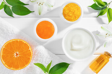 Natural beauty products with orange fruit on white wooden background. Organic beauty or SPA...
