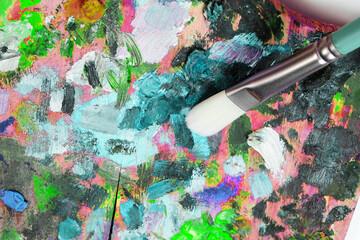 Palette with paints and art brush
