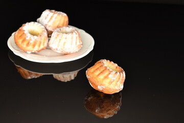 Fragrant sweet cupcakes, close-up, on a black background.