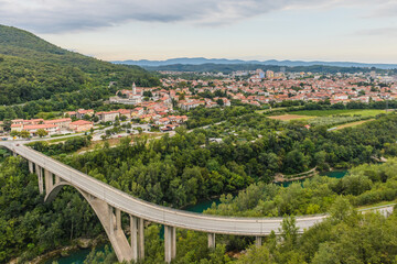 Bridge over Soca River with Nova Gorica town in background. Slovenia.