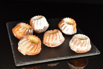 Fragrant sweet cupcakes, close-up, on a black background.