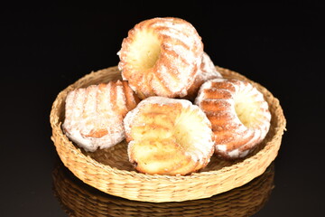 Fragrant sweet cupcakes, close-up, on a black background.