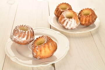 Fragrant sweet cupcakes, close-up, on a white wooden table.