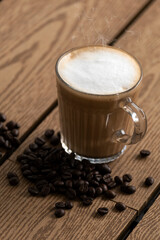Hot coffee latte and beans on the wooden floor