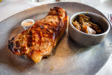Argentinian steak on a metal plate in La Boca neighborhood, Buenos Aires, Argentina.