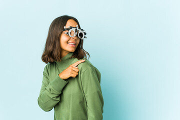 Young oculist latin woman over isolated background