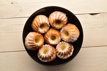 Fragrant sweet cupcakes, close-up, on a white wooden table.