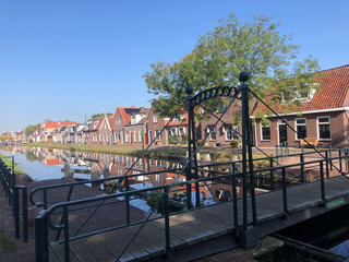 Fototapeta na wymiar Houses next to the canal in Gorredijk