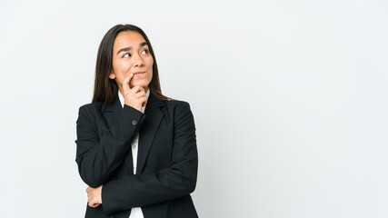 Young asian bussines woman isolated on white background looking sideways with doubtful and skeptical expression.
