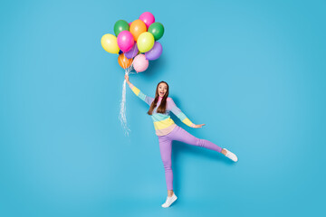Fototapeta na wymiar Full body photo of astonished girl hold catch air fly balloons scream wear pants isolated over blue color background