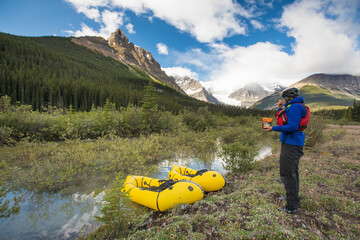 Paddler eats a backpackers meal out of a bag before his adventure.