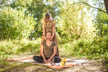 Expert masseuse adequately performs a great massage in nature.
