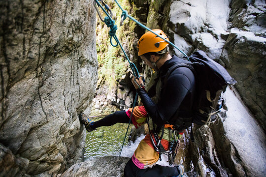 Man prepares to rappel down waterfall near Vancouver, Canada.