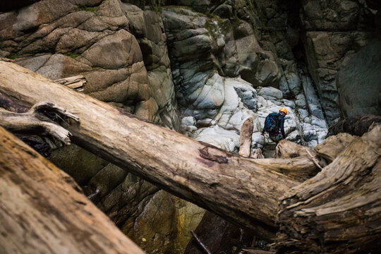 Man exploring, escaping in deep dark canyon near Vancouver, B.C.