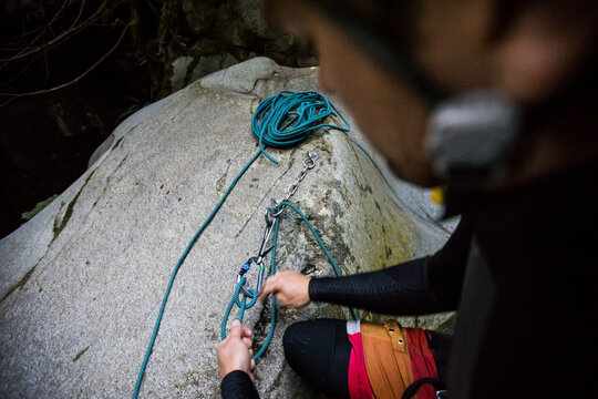 High angle view of climber setting up rappel station in canyon.