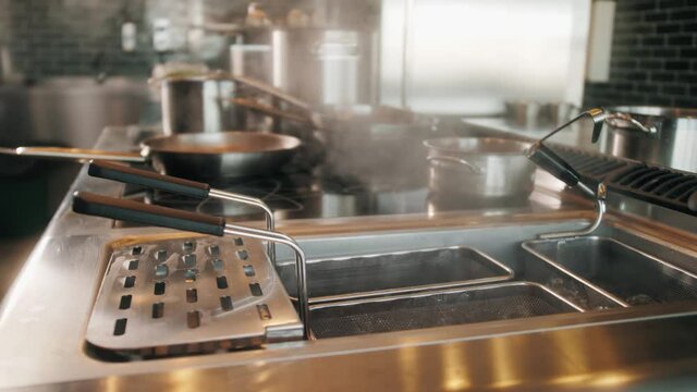 Boiling handmade pasta preparation. Spaghetti boiling, traditional italian fast food restaurant equipment. Industrial professional modern kitchen.