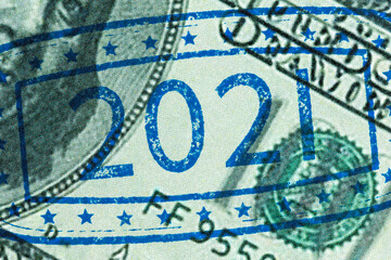 Ink stamp 2021 on hundred dollar bill