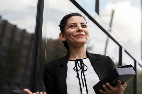 woman leader standing outside in front of a building