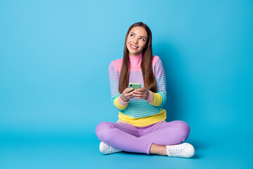 Portrait of nice creative cheerful girl sitting lotus position crossed legs creating post smm blog...