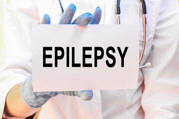 The doctor's blue - gloved hands show the word EPILEPSY - . a gloved hand on a white background. Medical concept. the medicine