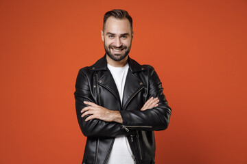 Smiling confident handsome young bearded man 20s wearing basic white t-shirt black leather jacket...
