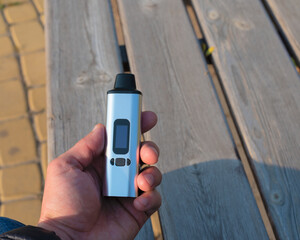 portable herbal vaporizer in human hand