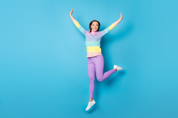 Fototapeta na wymiar Full length body size view of lovely glad careless cheerful girl jumping having fun walking isolated over bright blue color background
